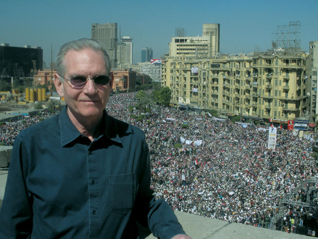 Marc Rauch ’69 stands atop the fifth story roof of the AUC Science Building, which fronts directly on Tahrir Square, where a crowd estimated at more than one million gathered on “Victory Friday,” February 18. Photo: Sean Graham